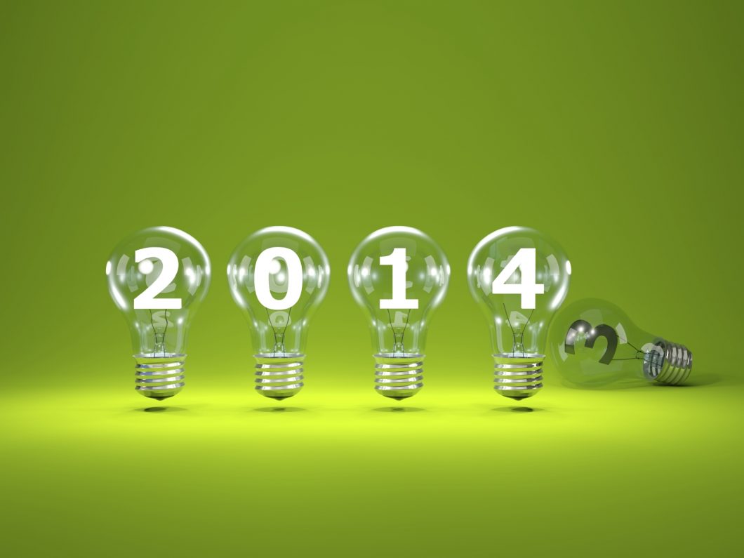 2014 New Year Sign Inside Light Bulbs On Green Background