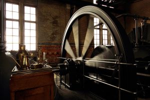 operating-steam-engine-with-running-fly-wheel-by-mgfoto-via-istock