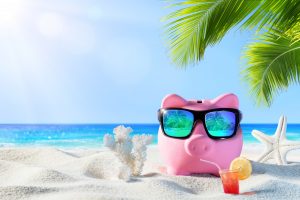 Piggy Bank With Sunglasses On The Beach Holiday