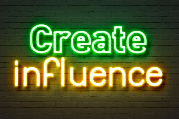 Create Influence Neon Sign On Brick Wall Background.