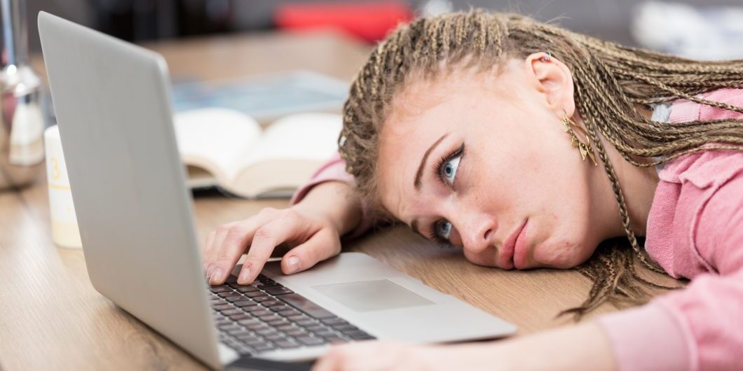 Bored Woman In Front Of Laptop