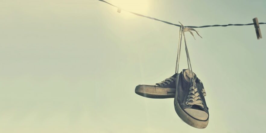 Dirty Sneakers Hanging On The Clothesline By Orla Via Shuterstock