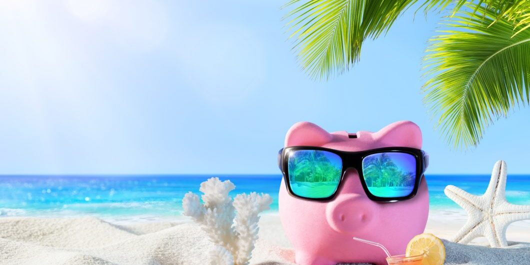 Piggy Bank With Sunglasses On The Beach Holiday